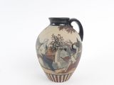 a vase with a painting on it sitting on a table