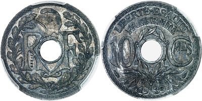 a close up of two silver coins on a white surface