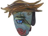 a glass sculpture of a woman ' s face on a wall