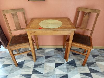 two chairs and a table with a plate on top of it