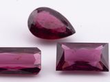 a pair of pink tourmaline gems on a white surface