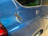 a blue car that has a sticker on the side of it