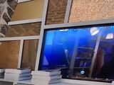 un homme assis à une table devant une télévision