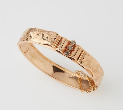 a close up of a gold ring with diamonds on a white background