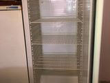 a refrigerator that is open in a kitchen