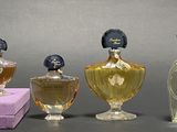 three bottles of perfume sitting next to each other on a table