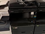 a lot of office printers sitting on top of each other