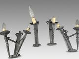 three metal candles with candles on each side of them on a gray background