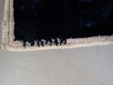 a close up of a black and white rug on a table