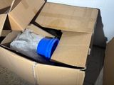 a cardboard box with a blue cup inside of it