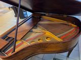a piano that is sitting on a table in a room