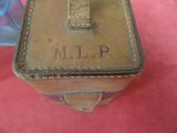 a small brown box with a cross on top of it
