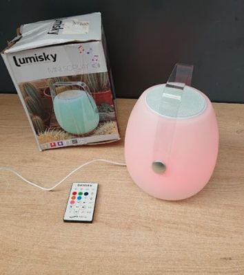 a remote control sitting on a table next to a lamp