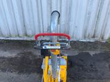 a small yellow scooter with a red handle on it
