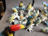 many figurines of birds that are sitting on a table