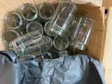 many empty glass jars in a box on the floor