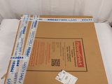 a cardboard box sitting on top of a bed in a room