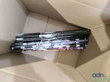 a cardboard box that has a bunch of pens inside of it