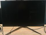 the flat screen tv is sitting on a wooden table next to a wall
