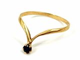 a close up of a gold ring with a black diamond