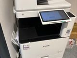 a photo of a multi - function printer with a tablet on top of it