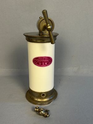 an old fashioned coffee grinder is sitting on a table