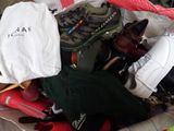 a bag full of shoes and a bag with a t - shirt