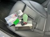 the interior of a car with a bunch of items in the back seat