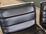 two black leather chairs that are sitting on a tile floor