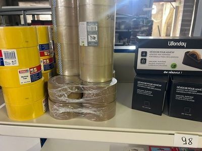 many rolls of tape on a shelf in a store
