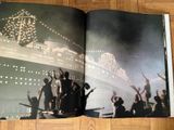an open book with a picture of a cruise ship in the background
