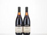 two bottles of wine sitting on top of a table next to each other