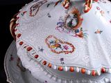 a white plate with a lid that has a design on it