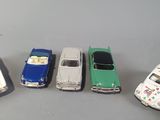 several toy cars are lined up in a row on a table