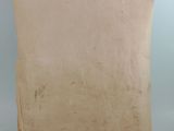 an old piece of paper sitting on top of a wooden stand