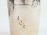 a silver cup with writing on it sitting on a table