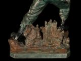 statue of a man with a gun and a dog on a black background
