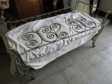a bed with a white sheet on it in a room