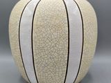 a white vase with a cracky design on it