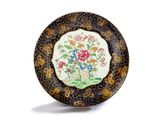 a plate with a floral design on it on a white surface