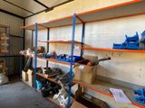 many shelves that have various items on them in the room