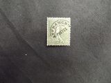 a stamp with an indian head on it sitting on a black surface