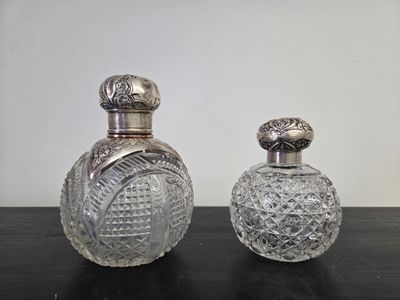 pair of antique cut glass perfume bottles on a table