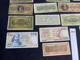 several different types of paper money are displayed on a table