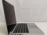 an open laptop computer sitting on top of a table next to a white curtain