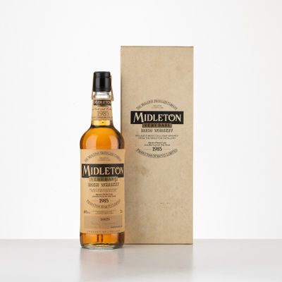 une bouteille de whisky posée à côté d'un carton sur une table
