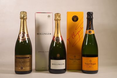 three bottles of champagne sitting next to each other in front of a box