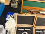 a box of tools sitting on a table next to a pair of scissors