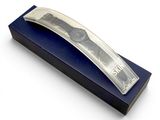 a silver money clip in a blue box on a white surface