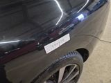 a black car with a sticker on the side of it